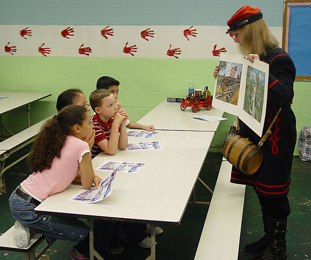 The mascot with the US flag is the Union mascot.  The soldiers with him are wearing blue uniforms.  The soldiers with the Confederate mascot are wearing gray uniforms.
