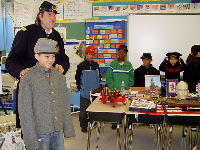 There is a Confederate in the class.  Check out the gray uniform.