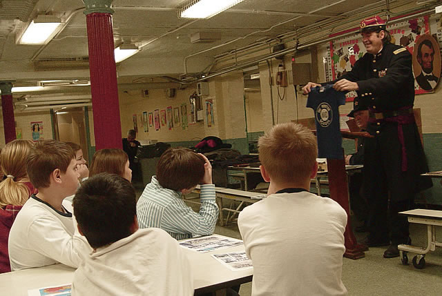 George remembers wearing his PS 110 The Monitor School's shirt.  Do you think it still fits?