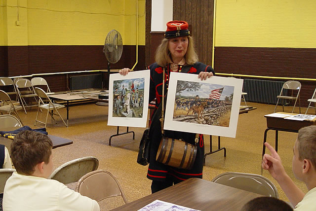 Stonewall was a Confederate mascot.  He is with the soldiers in grey carrying the Confederate flag.  Sallie was a Union mascot.  She is with the soldiers in blue carrying a Union flag.