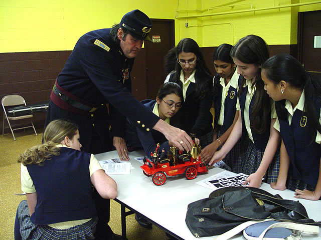 Future engineers learning how a steam fire engine works.